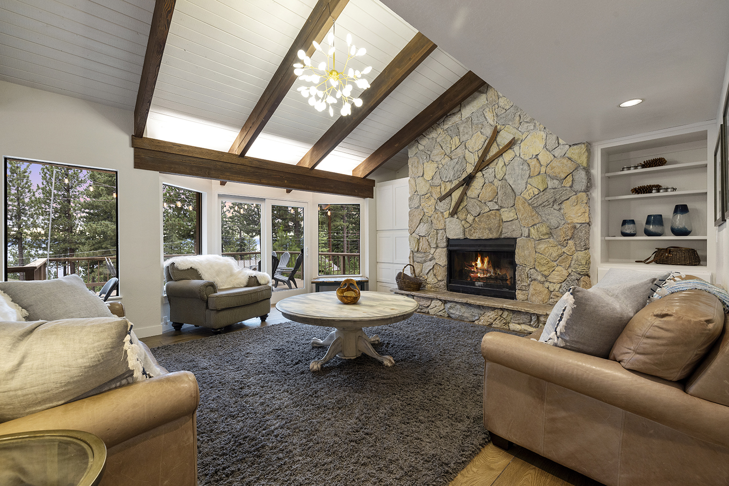 Spacious living room with fireplace and view of Lake Tahoe at Tahoe vacation rental