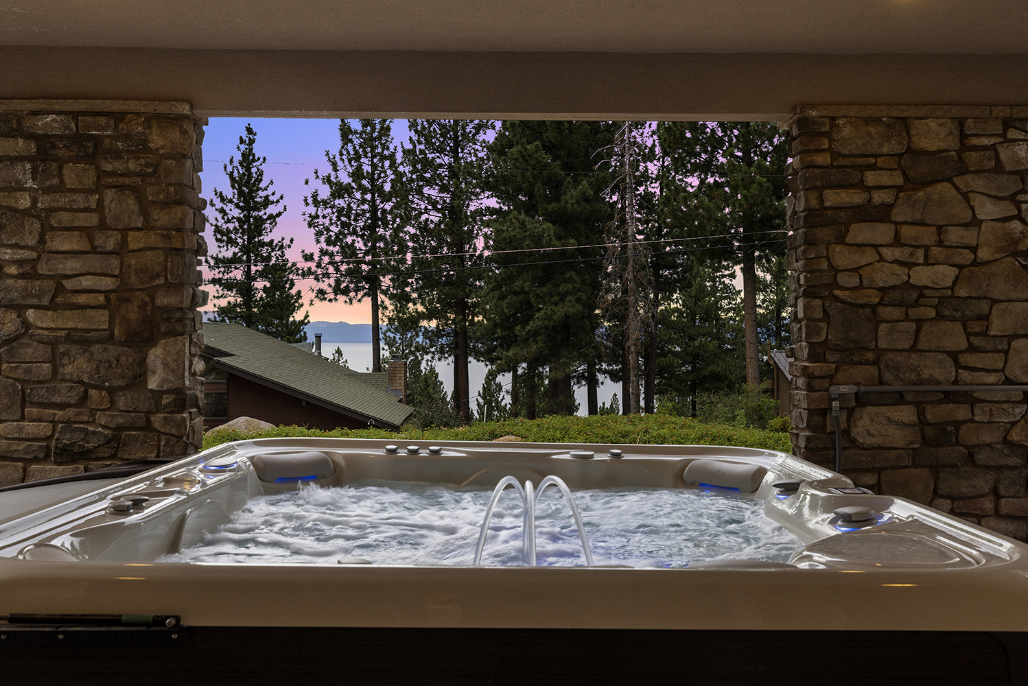 Huge 7-seat hot tub with view of Lake Tahoe and sunset at Tahoe vacation rental
